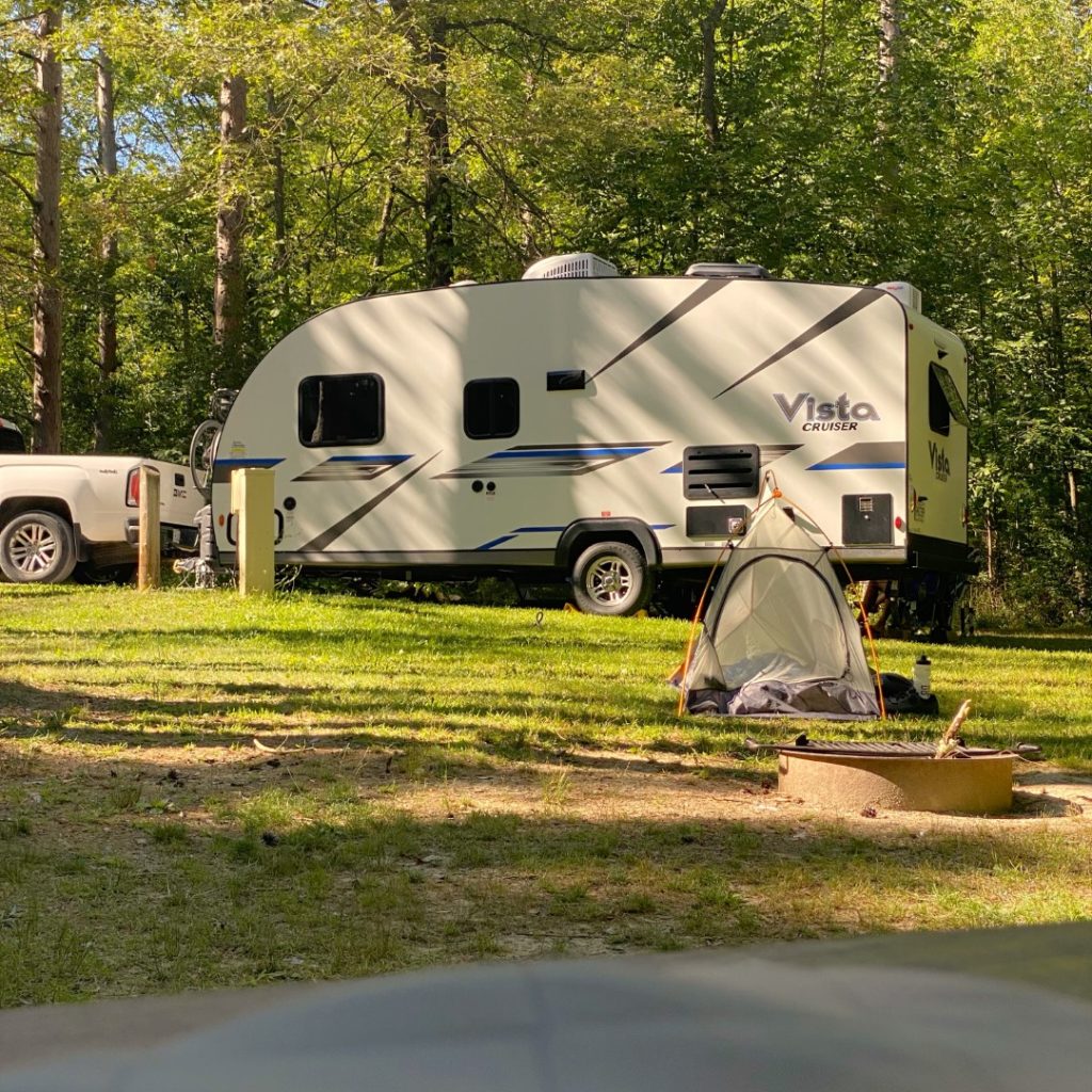 Bike Camping in Letchworth State Park in NY. Showing tent next to large RV.