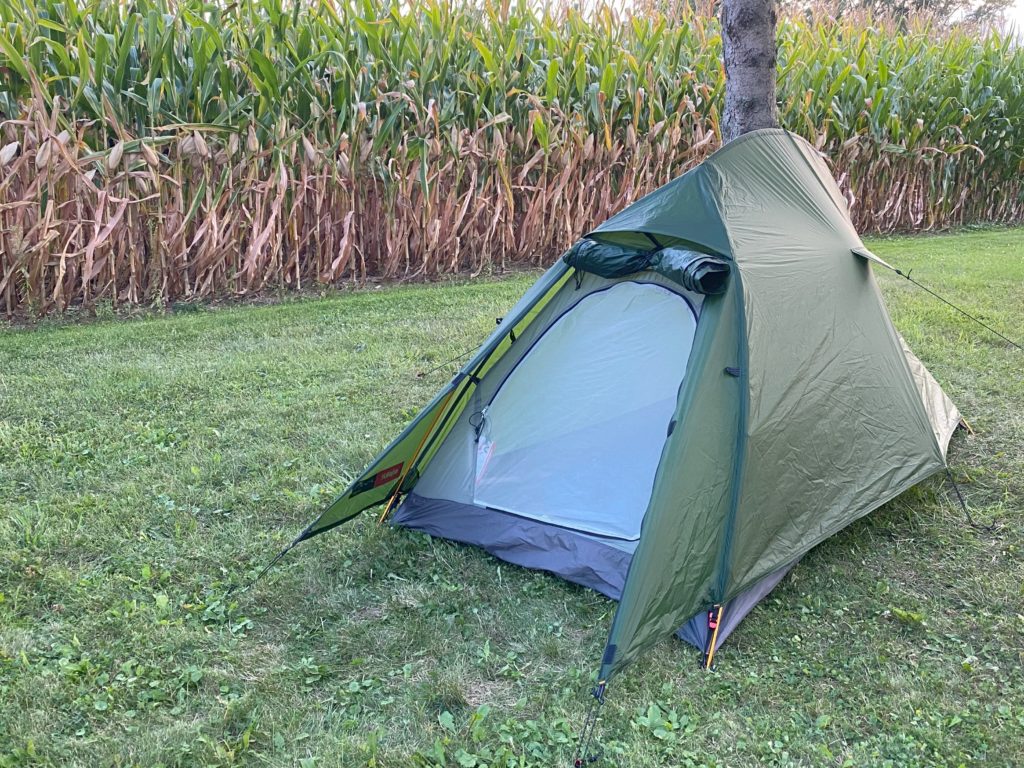 Bivvy-style tent next to a field.
