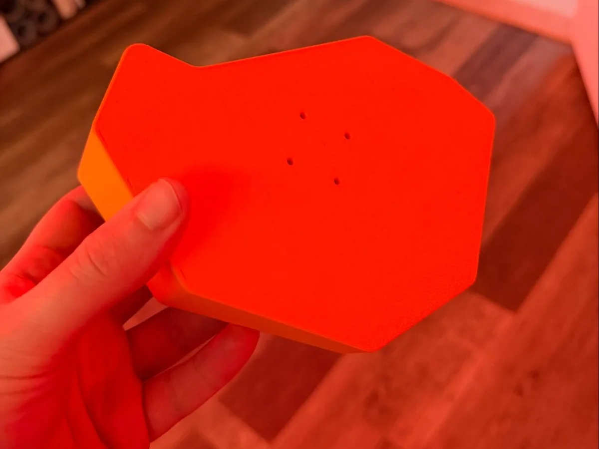 Underside of the finished orange platform held in one hand.